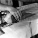 A woman works on a old traditional woven machine