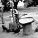 A woman grinds grain to make flour in a small village along the Mekong river