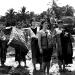Women who live on the Mekong river banks village try to sell silk for people on a boat