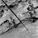 Children slide on mud and jump into Mekong river