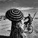 A girl have whirlpool umbrella to protect her skin against the desert sun.