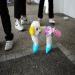 A dog dyed with flashy colors wears a skirt in Hong Kong