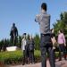 Un couple de personnes ges se fait photographier devant la statue de Deng Xiaoping dans un parc de Shenzhen.